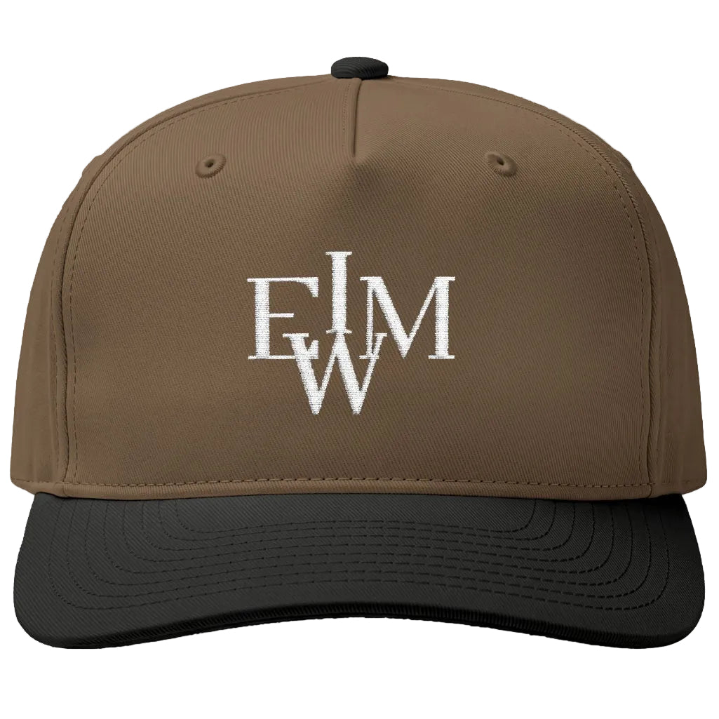 A structured baseball cap with a brown crown and a black curved brim, featuring a white embroidered monogram logo on the front.