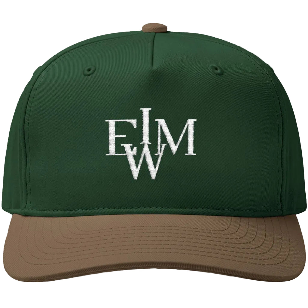 A structured baseball cap with a dark forest green crown and a brown visor, featuring a white embroidered monogram logo on the front.