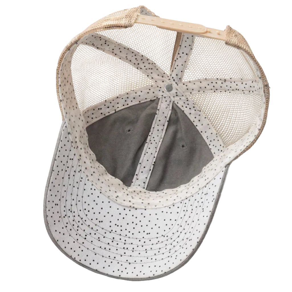 Baseball cap with mesh back and polka dot pattern on a white background