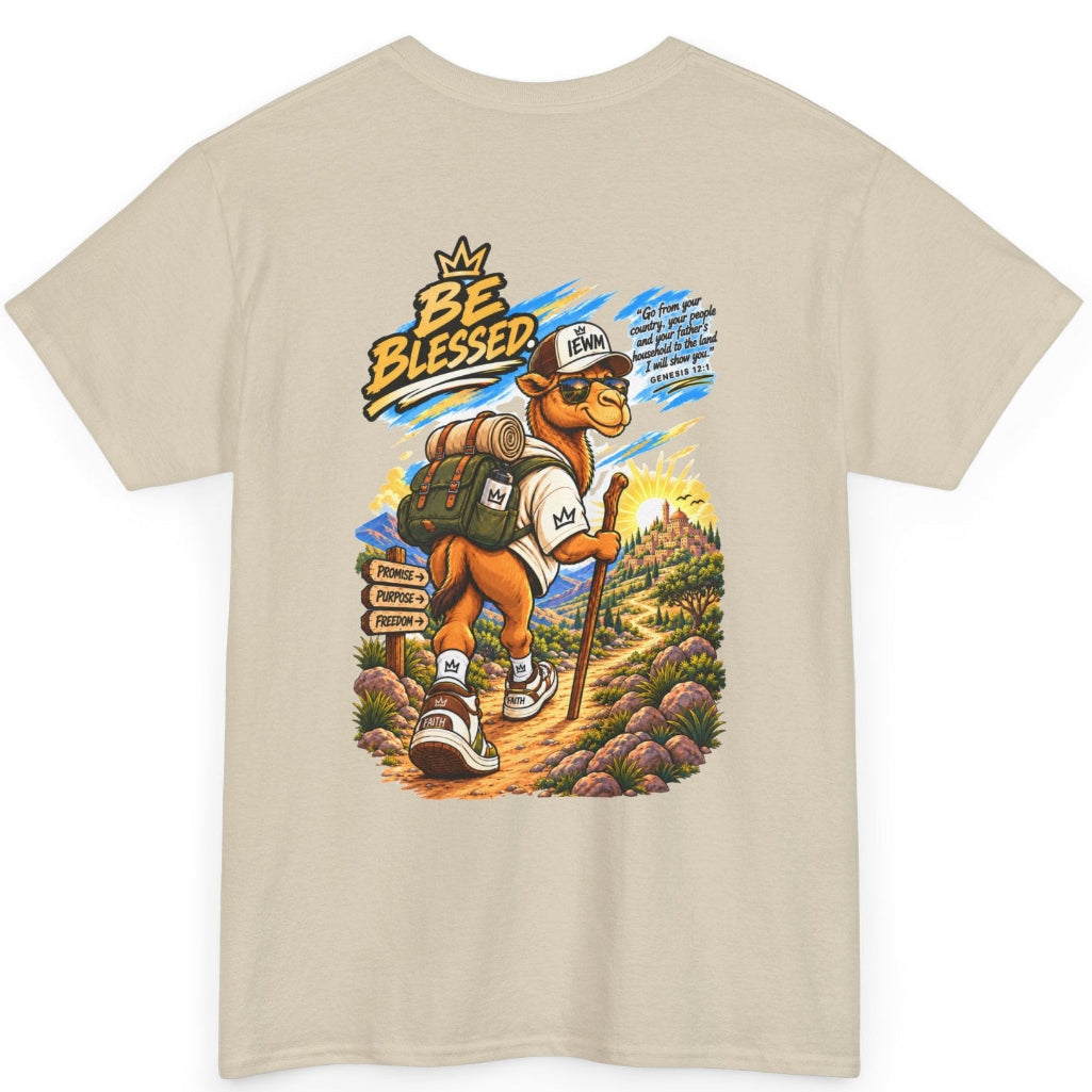 A Sand crewneck t-shirt with a colorful graphic print on the front. The graphic features a cartoon camel wearing a baseball cap and backpack, hiking on a trail with the text 'BE BLESSED' 
