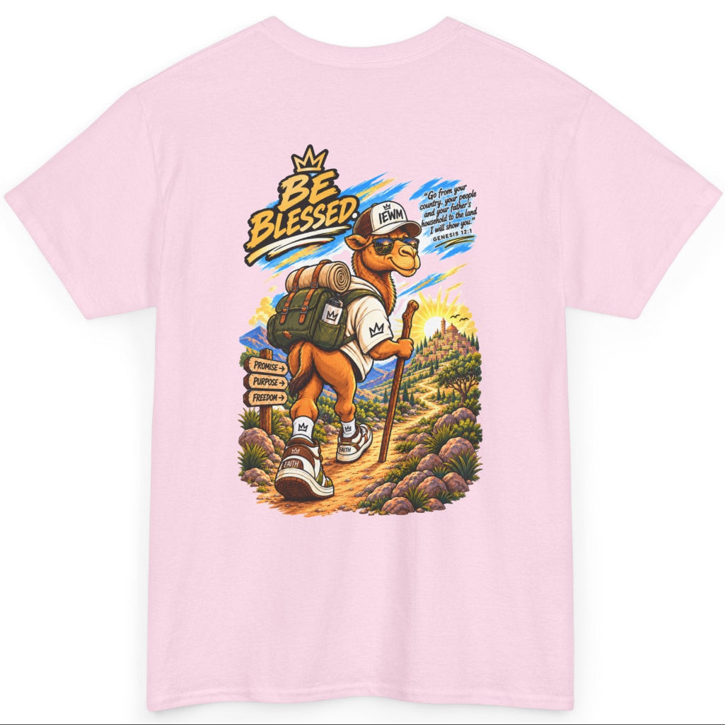 A light pink short-sleeve t-shirt with a large, colorful graphic print on the back. The graphic features a cartoon hiking camel wearing a white baseball cap with 'IEWM' written on it, set against a scenic mountain background.