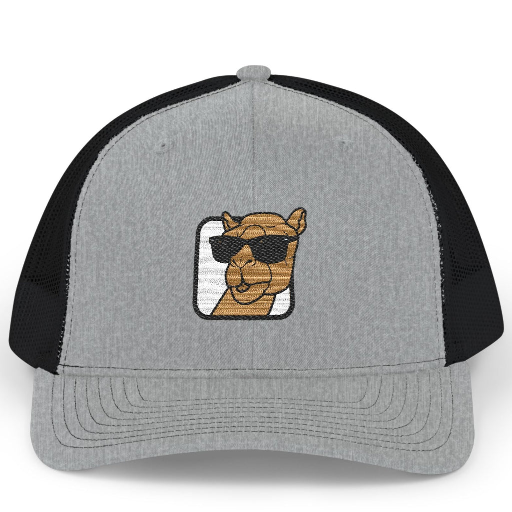 A gray and black trucker hat featuring an embroidered camel wearing sunglasses on the front panel, set against a plain white background.