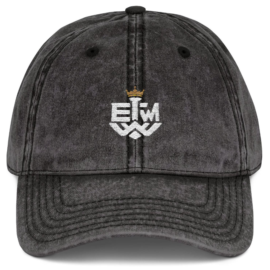 Black distressed cap with 'IEWM' text and gold crown on a white background