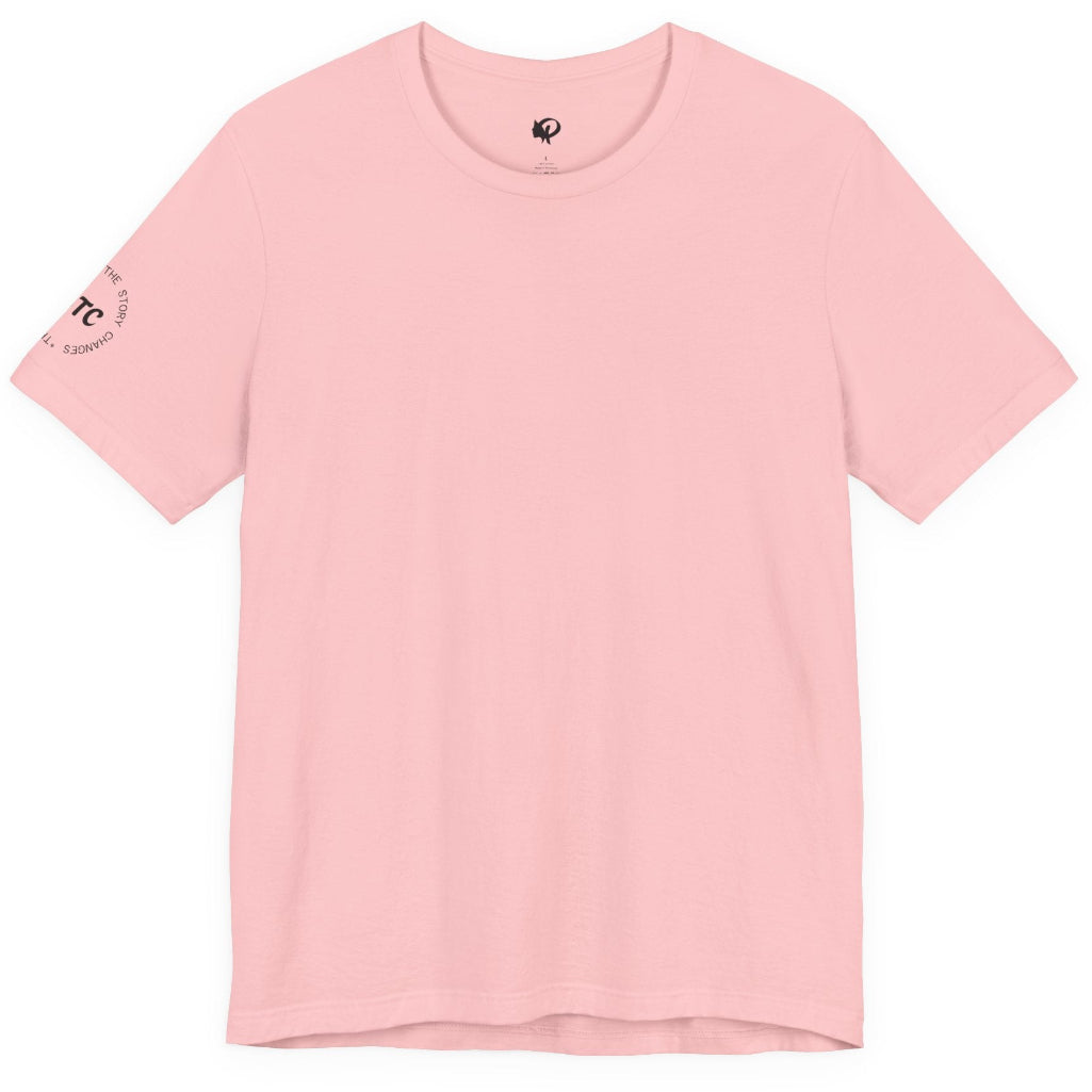 A light pink short-sleeve crewneck t-shirt with a small circular black graphic printed on the left sleeve, displayed flat against a solid white background.