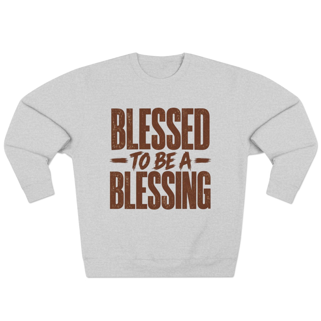 A light heather gray crewneck sweatshirt with a distressed brown graphic text reading 'BLESSED TO BE A BLESSING' on the front, displayed against a solid white background.