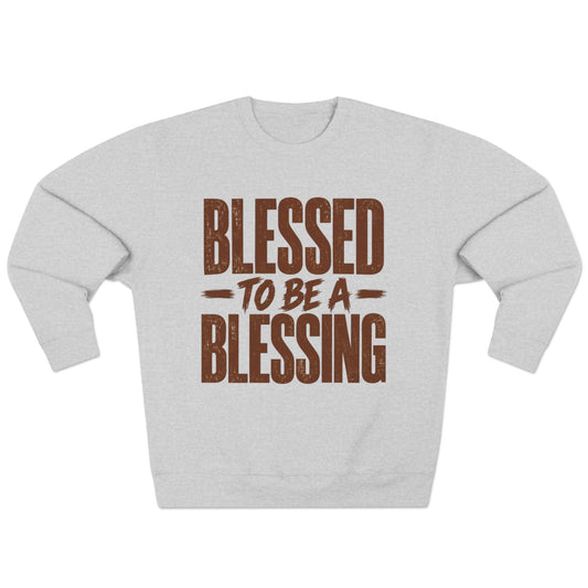 A light heather gray crewneck sweatshirt with a distressed brown graphic text reading 'BLESSED TO BE A BLESSING' on the front, displayed against a solid white background.