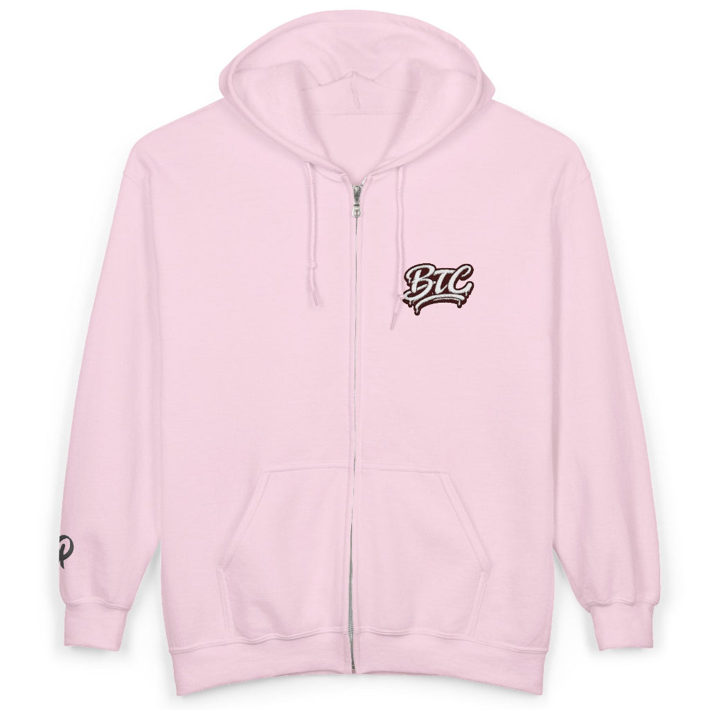 A light pink zip-up hoodie with a drawstring hood, kangaroo pockets, and a stylized black and white 'BTL' graphic on the left chest, displayed on a clean white background.