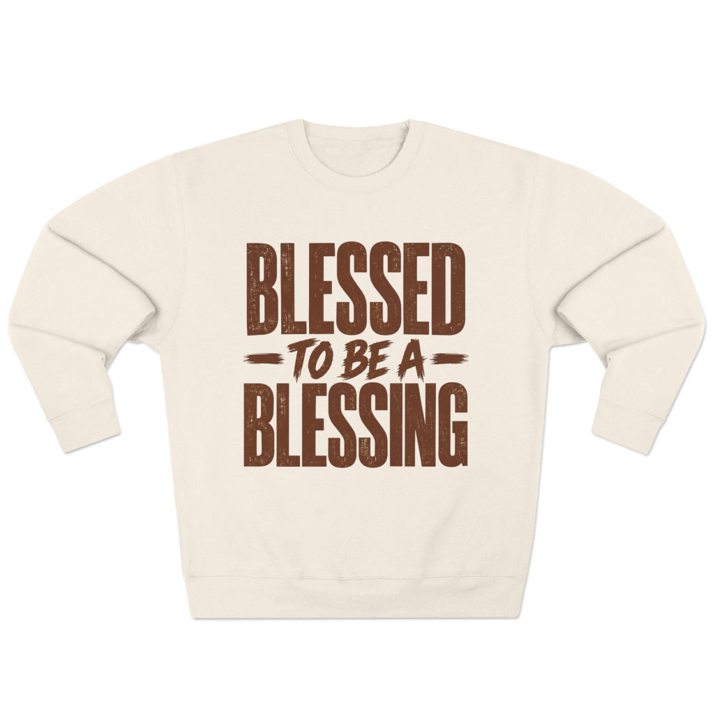 An sandshell colored crewneck sweatshirt with a distressed brown graphic print on the front that reads 'BLESSED TO BE A BLESSING'.