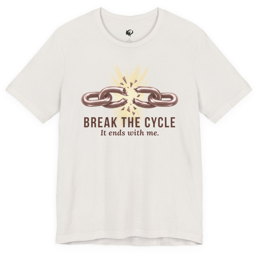 An off-white short-sleeve t-shirt with a graphic on the chest showing a broken chain and the text 'BREAK THE CYCLE It ends with me.' in brown and beige, displayed on a clean white background.