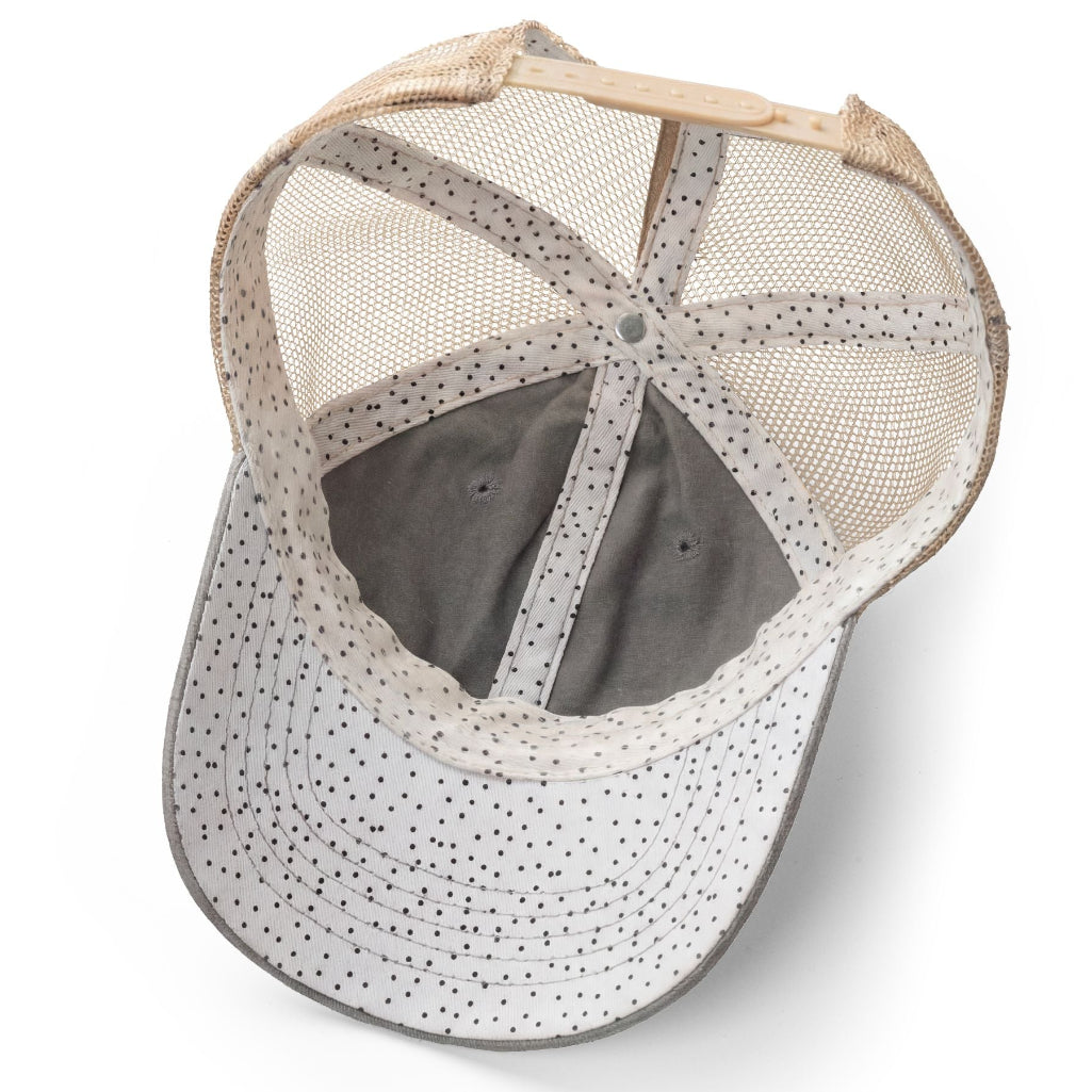Baseball cap with mesh back and polka dot pattern on a white background